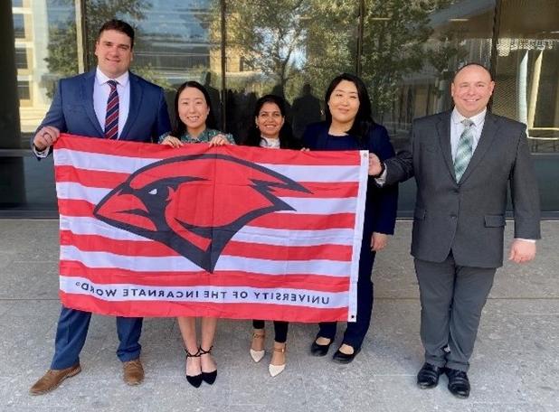 MHA Students at ACHE Student Symposium with UIW Flag